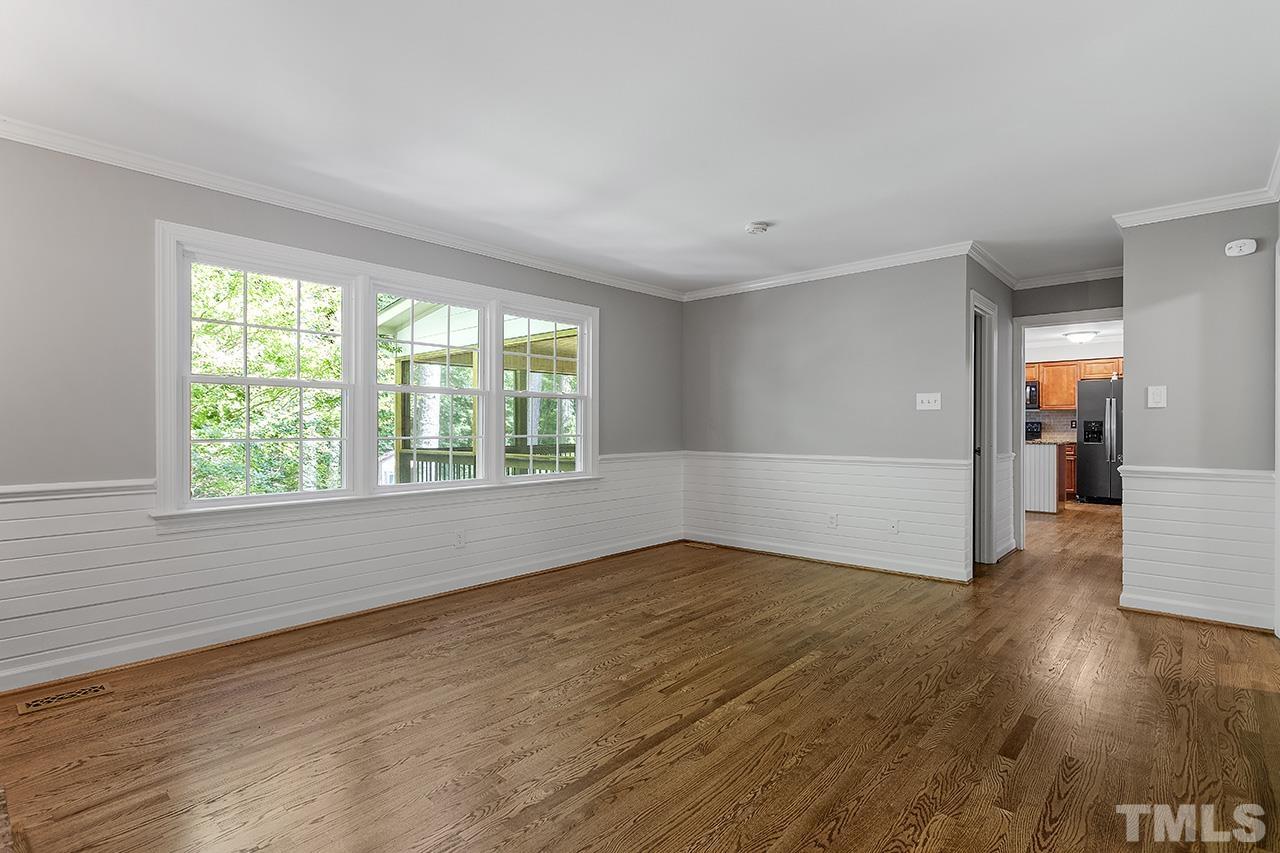 8408 Morgans Way Raleigh, NC 27613 - Photo 7 of 34 an empty room with wooden floor and windows