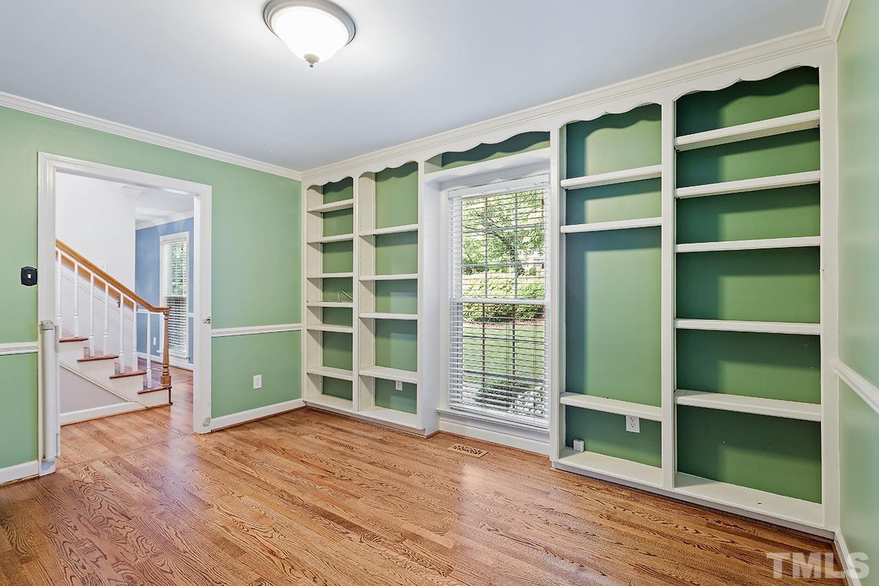 8408 Morgans Way Raleigh, NC 27613 - Photo 9 of 34 a view of an empty room with a window and wooden floor