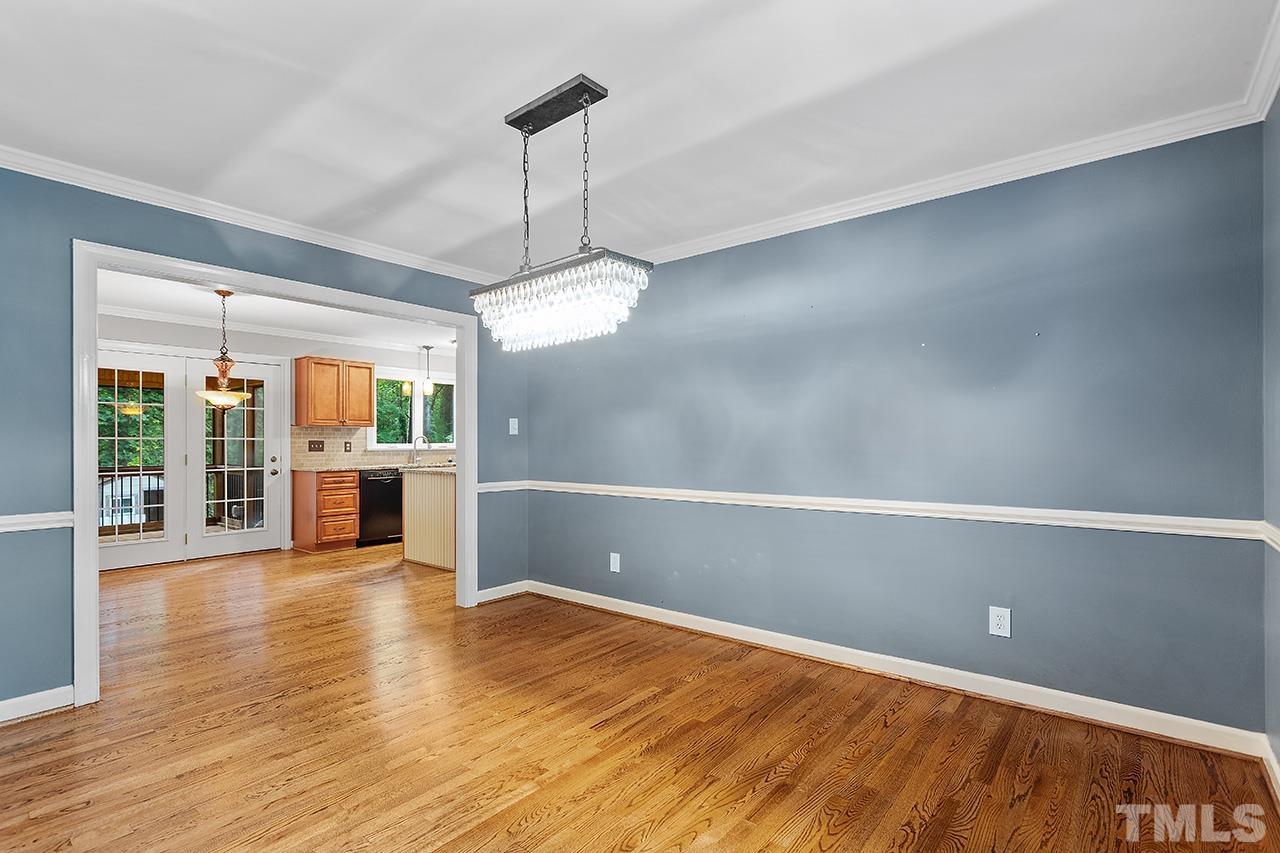8408 Morgans Way Raleigh, NC 27613 - Photo 10 of 34 a view of a room with wooden floor fireplace and windows