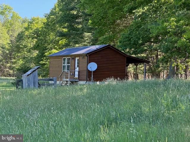 184 Skiles- Pitsenbarger Road Franklin, WV 26807 - Photo 5 of 39 Charming cabin nestled in lush greenery.