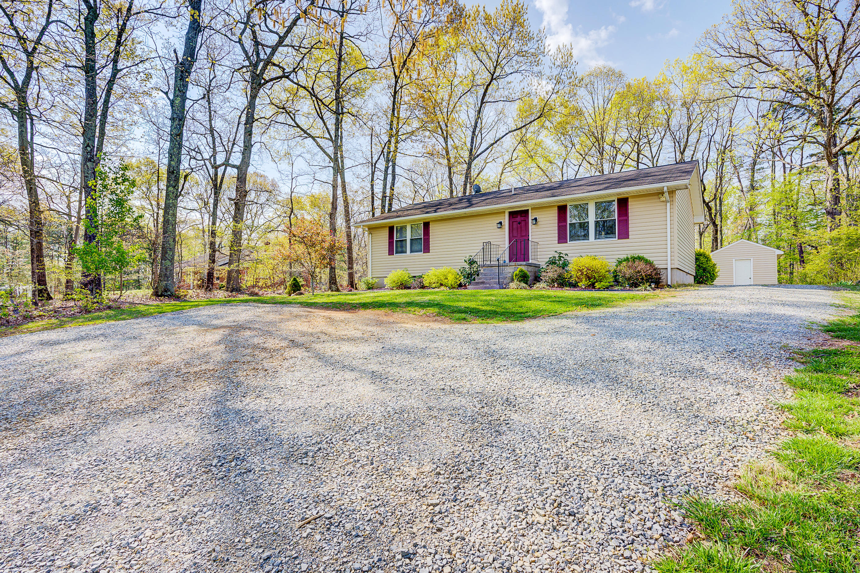 12267 Hardy Road Hardy, VA 24101 - Photo 2 of 24 a view of a brick house next to a yard with big trees