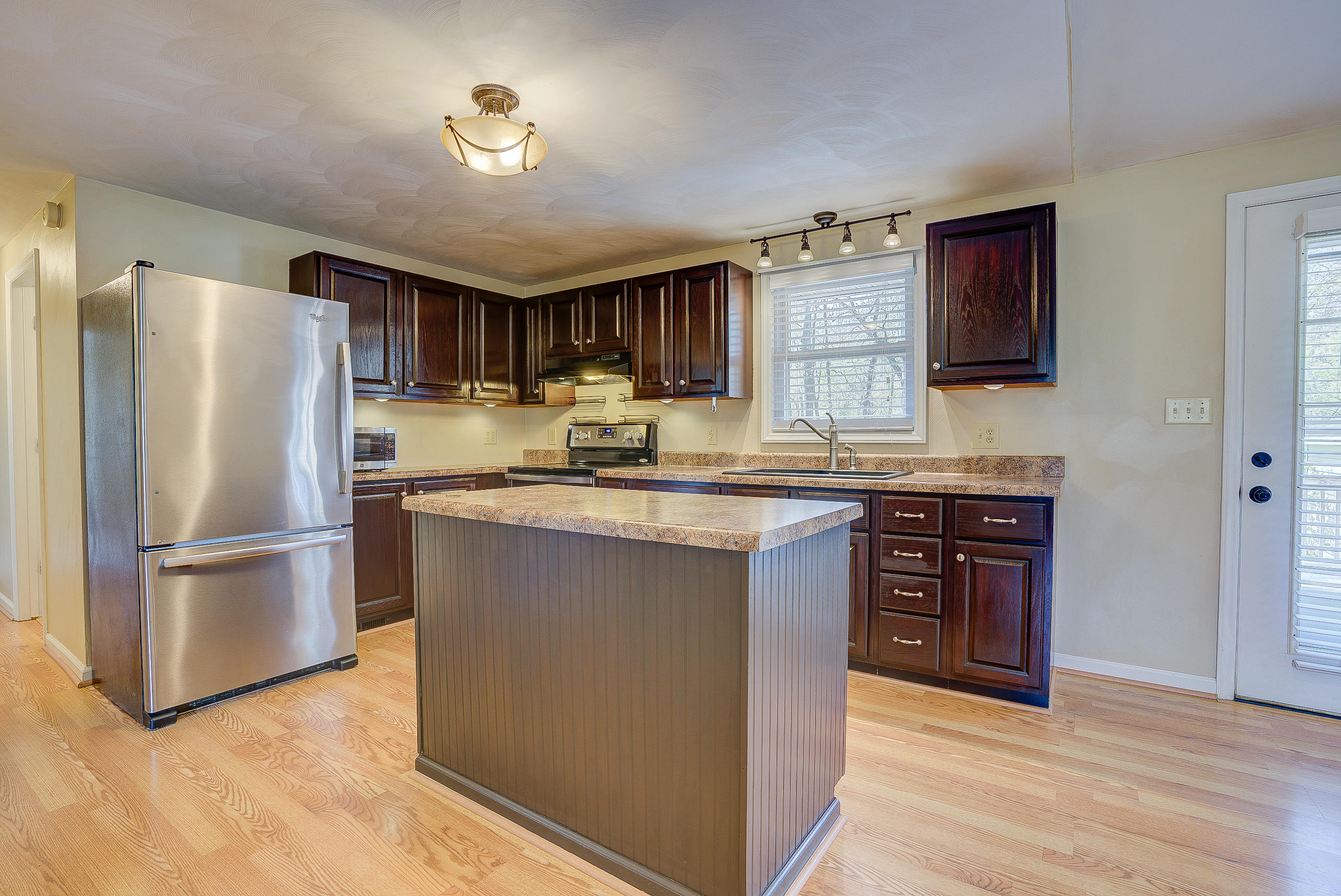 12267 Hardy Road Hardy, VA 24101 - Photo 11 of 24 a kitchen with kitchen island granite countertop stainless steel appliances and wooden cabinets