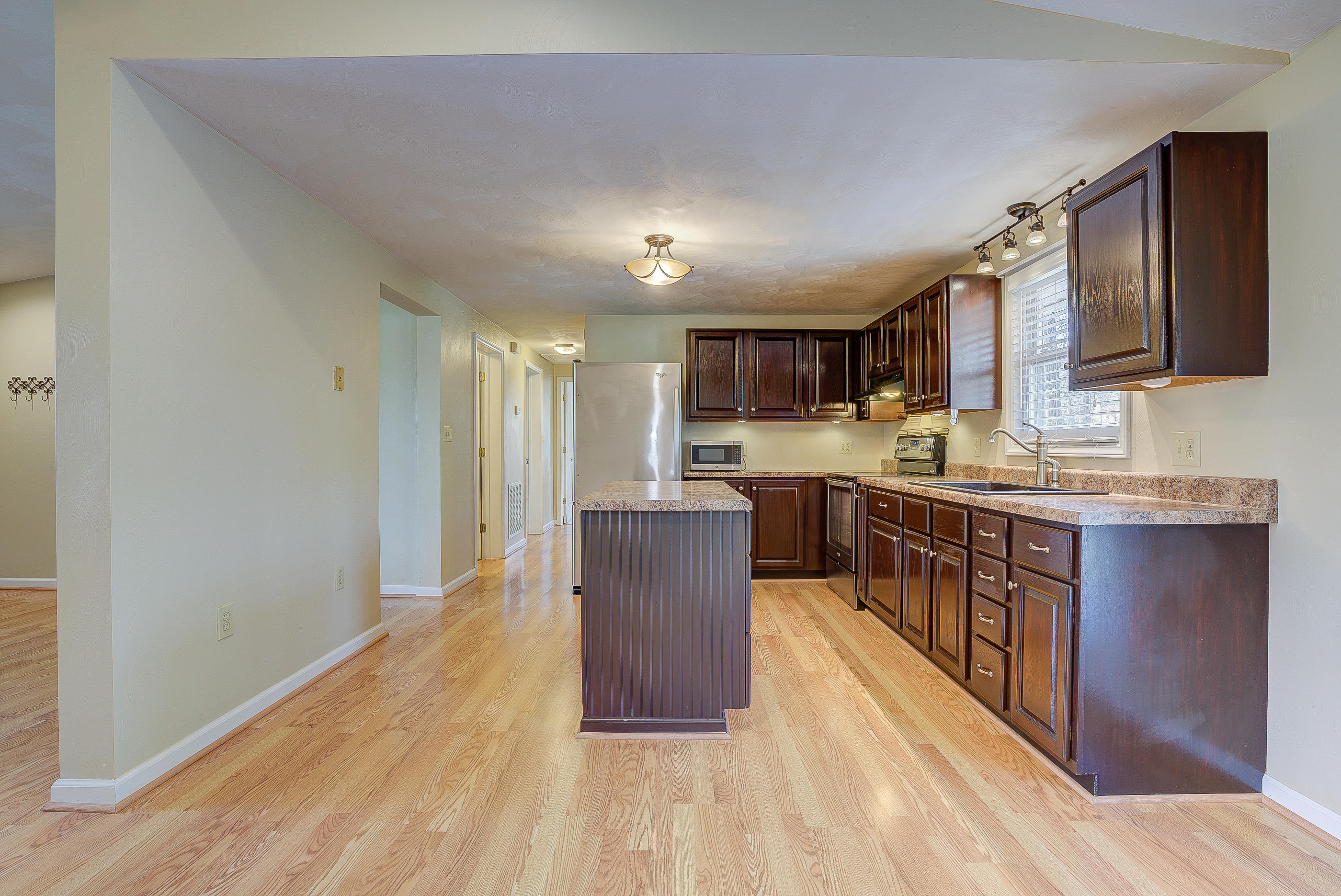 12267 Hardy Road Hardy, VA 24101 - Photo 9 of 24 a large kitchen with stainless steel appliances granite countertop a lot of cabinets and wooden floor