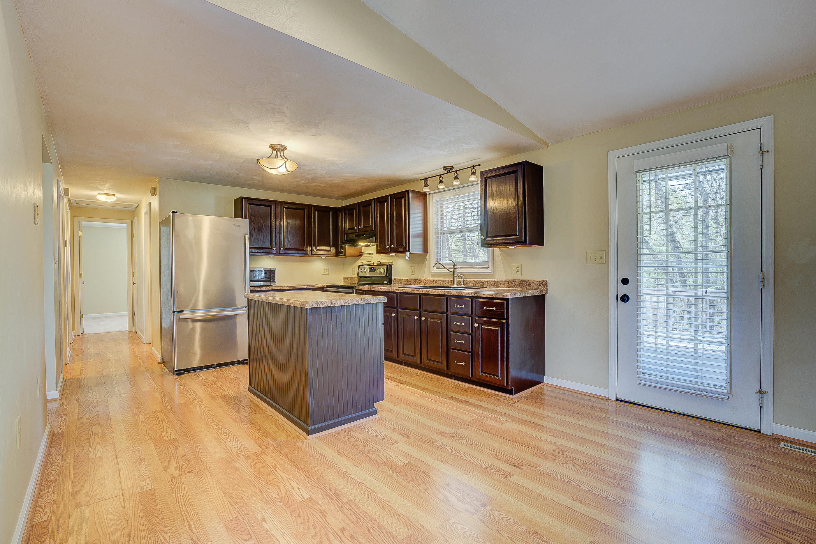 12267 Hardy Road Hardy, VA 24101 - Photo 10 of 24 a large kitchen with stainless steel appliances granite countertop a stove a sink dishwasher a refrigerator and a oven with wooden floor