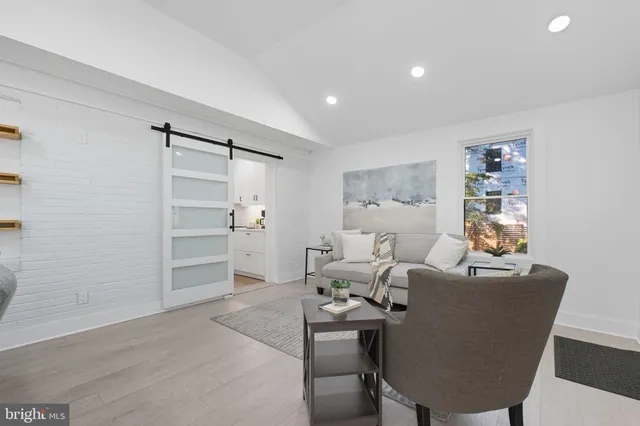 a living room with furniture and a closet