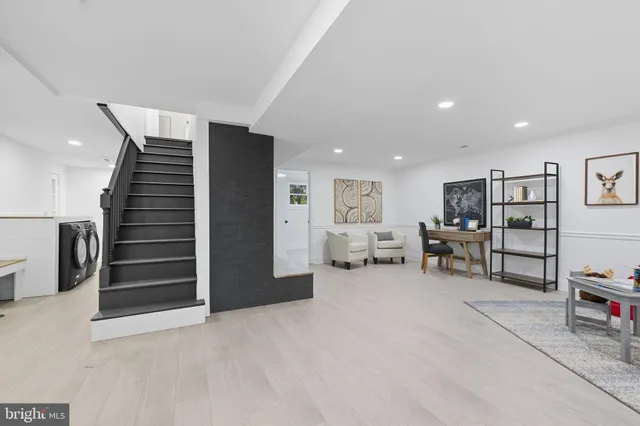 a view of a livingroom with furniture and stairs