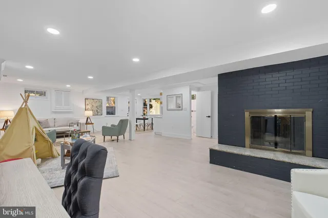 a living room with furniture a dining table and kitchen view