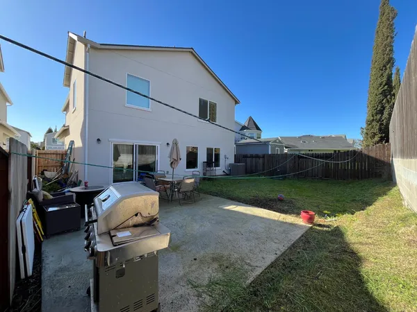 a view of a house with backyard and sitting area