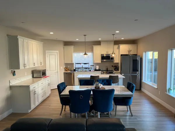 a kitchen with a dining table chairs and view kitchen