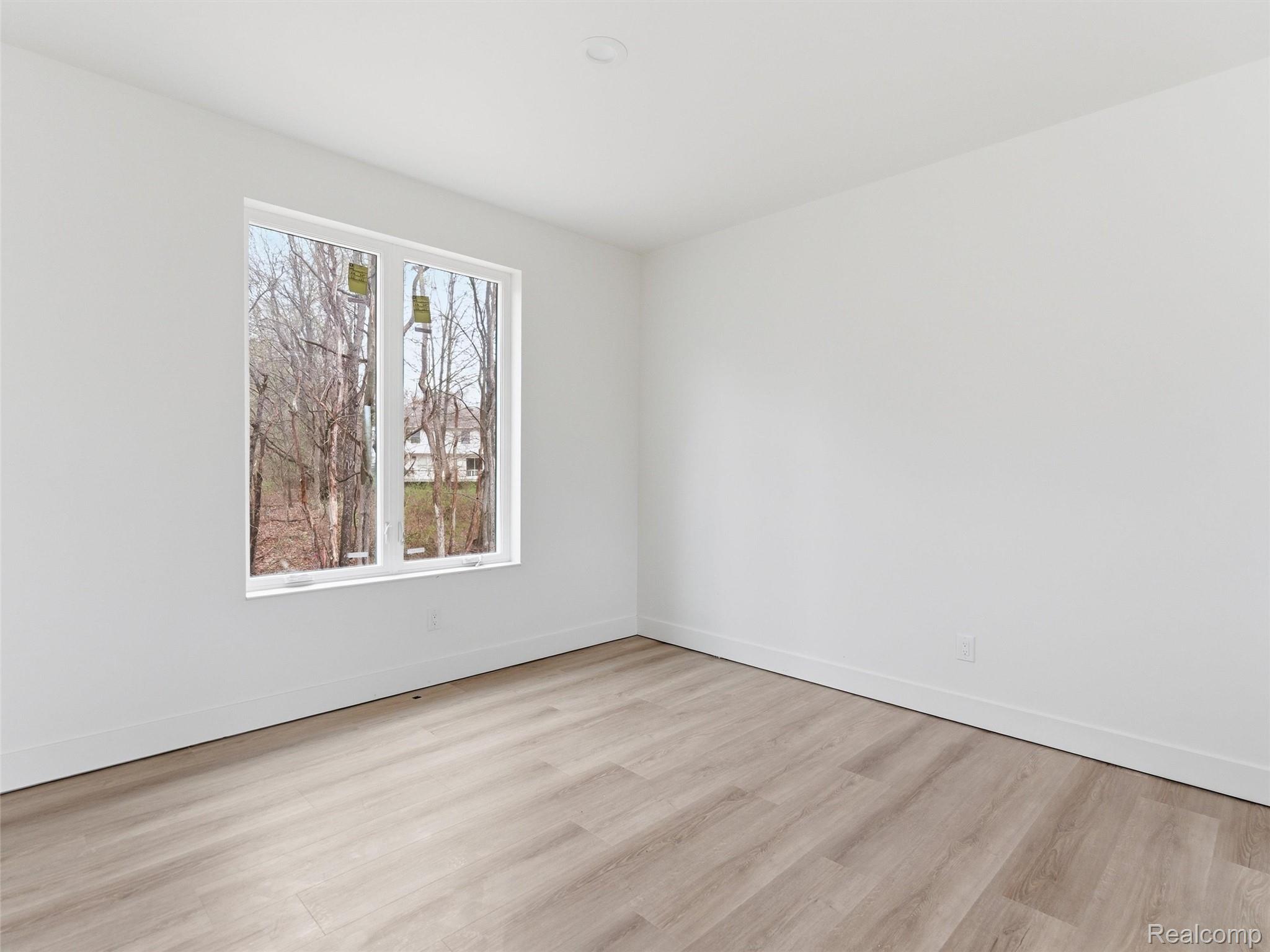 11810 Scenic Valley Road Davisburg, MI 48350 - Photo 17 of 46 Unfurnished room featuring baseboards and light wood finished floors
