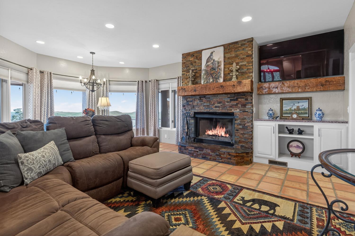 7570 Airola Road Vallecito, CA 95251 - Photo 20 of 90 a living room with furniture a flat screen tv and a fireplace