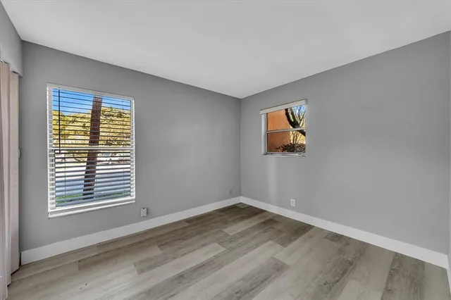 a view of a room with wooden floor