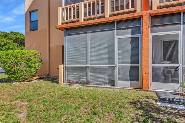 a view of a swimming pool with a patio and a yard