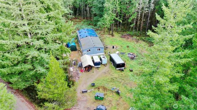 an aerial view of a house with a yard