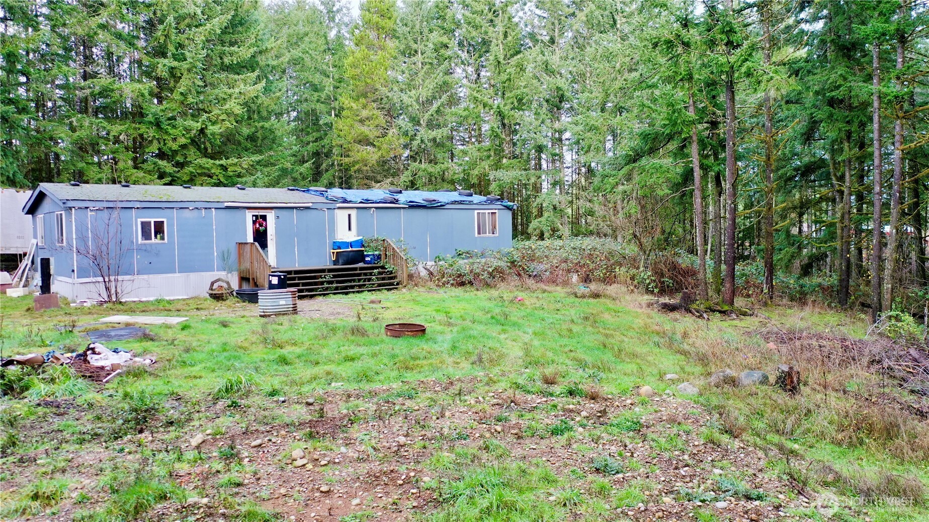 10185 May Ranch Lane Southwest Port Orchard, WA 98367 - Photo 5 of 14 a backyard of a house with table and chairs