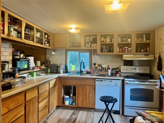 a kitchen with a stove a sink and cabinets