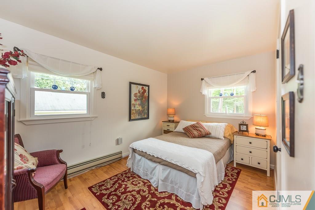 21 Mill Street Stockton, NJ 08559 - Photo 13 of 25 a bedroom with a bed and wooden floor