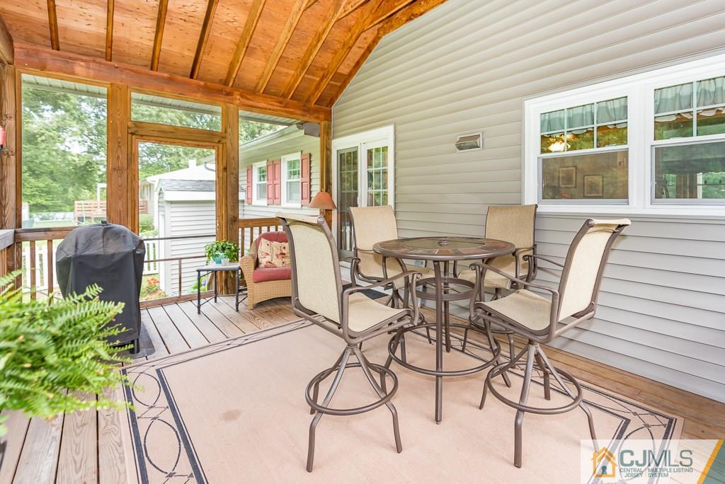 21 Mill Street Stockton, NJ 08559 - Photo 23 of 25 a view of a patio with table and chairs and wooden floor