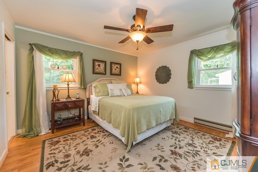 21 Mill Street Stockton, NJ 08559 - Photo 8 of 25 a bedroom with a bed and a chandelier