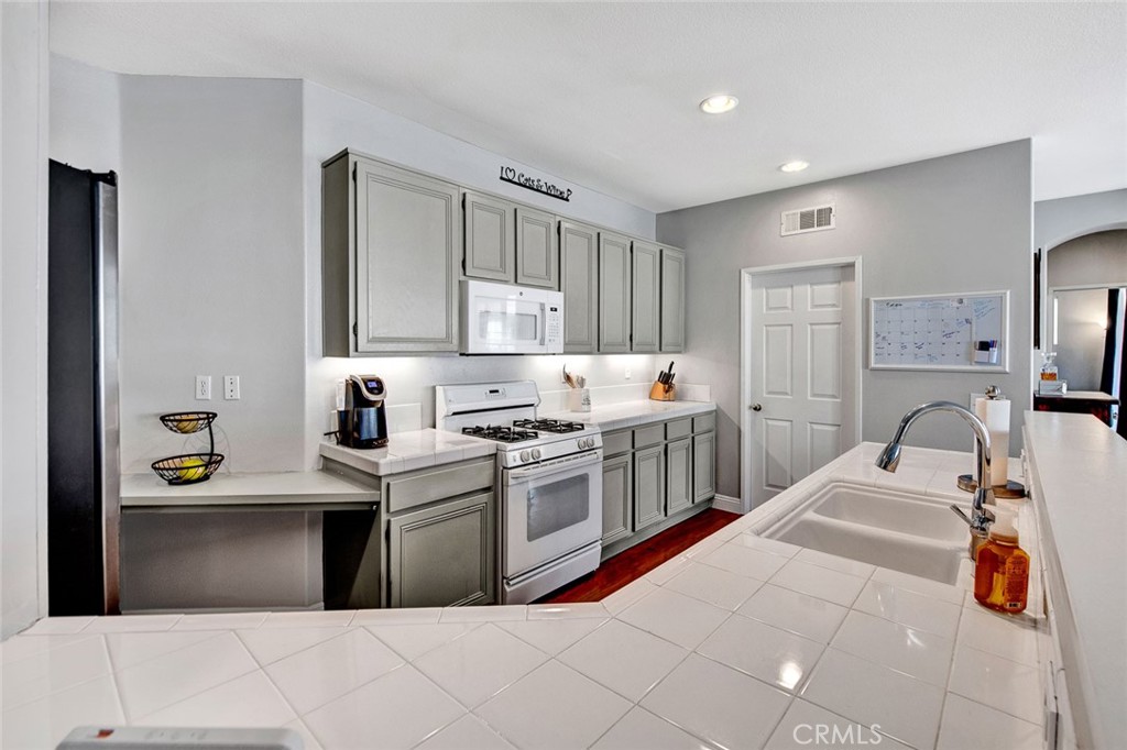 9 Darlington Irvine, CA 92620 - Photo 7 of 21 a kitchen with stainless steel appliances kitchen island granite countertop a sink and cabinets