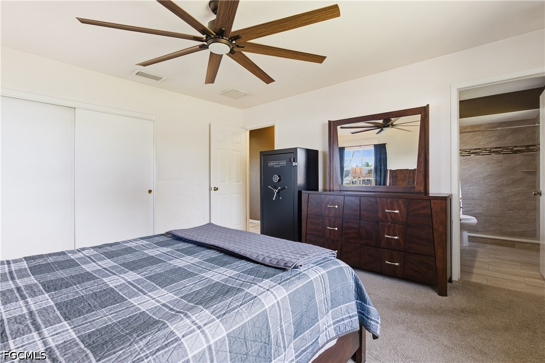 4960 20th Place Southwest Naples, FL 34116 - Photo 14 of 33 a bedroom with a bed and a dresser