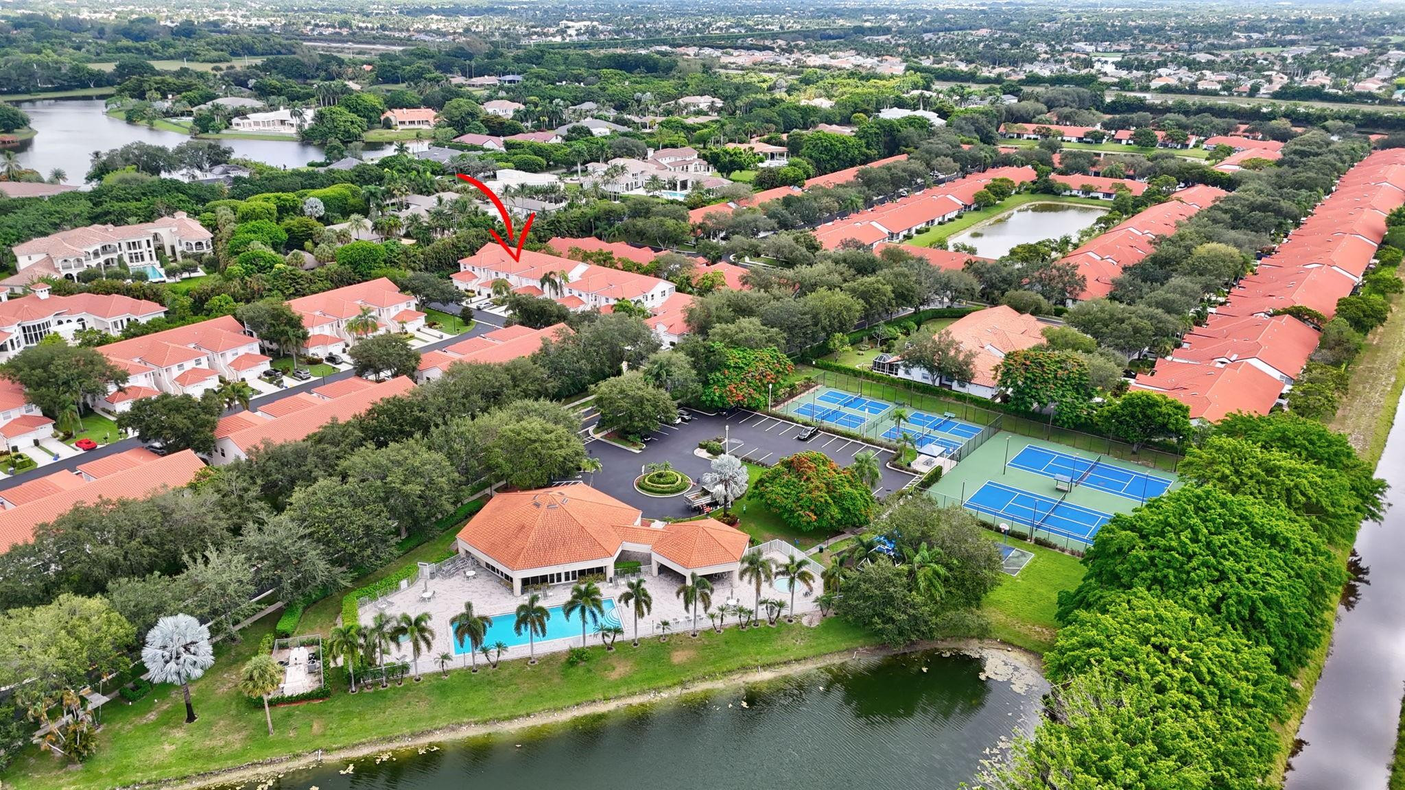 an aerial view of residential houses with outdoor space and lake view