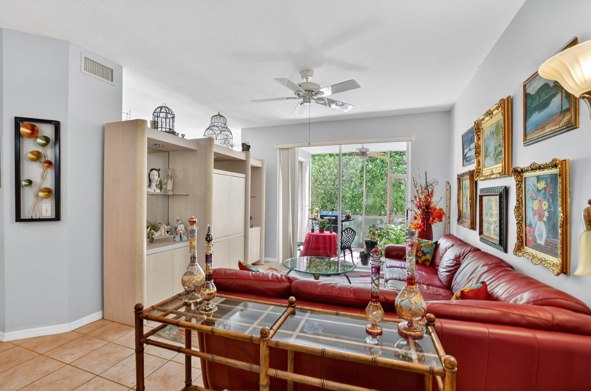 12614 Tiboli Chase Court, Unit 1 Boca Raton, FL 33496 - Photo 12 of 62 a living room with furniture a flat screen tv and a large window
