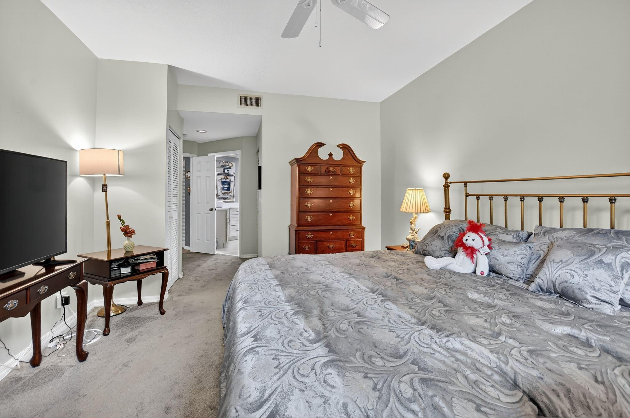 12614 Tiboli Chase Court, Unit 1 Boca Raton, FL 33496 - Photo 20 of 62 a bedroom with furniture and a flat screen tv