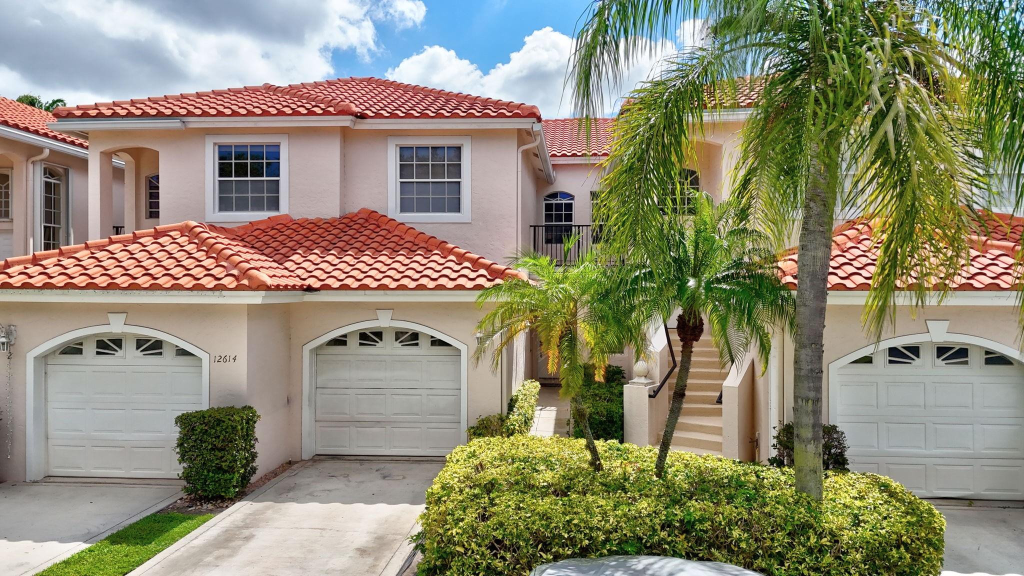 12614 Tiboli Chase Court, Unit 1 Boca Raton, FL 33496 - Photo 2 of 62 a front view of a house with garden