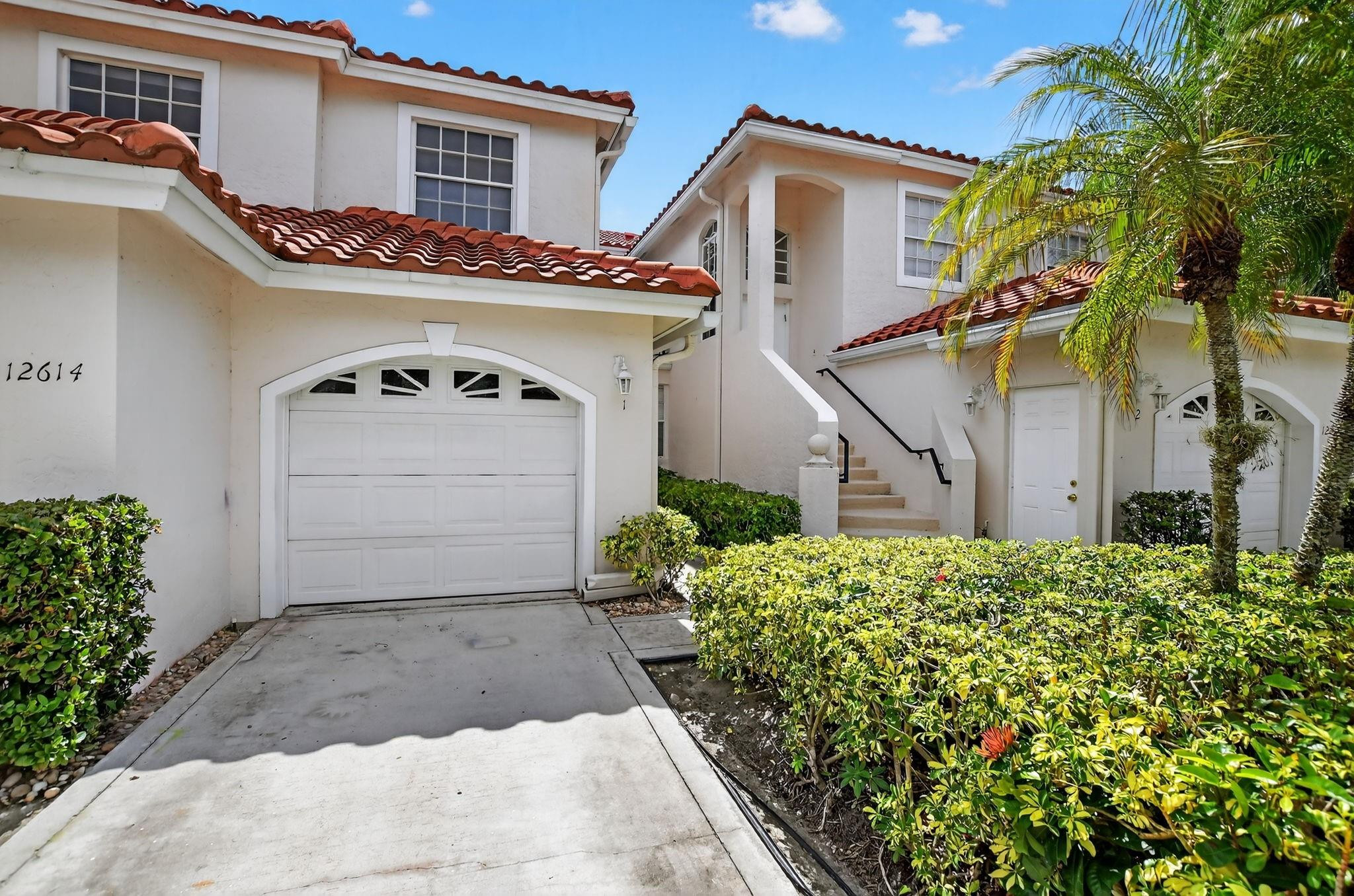 12614 Tiboli Chase Court, Unit 1 Boca Raton, FL 33496 - Photo 8 of 62 a front view of a house with garden