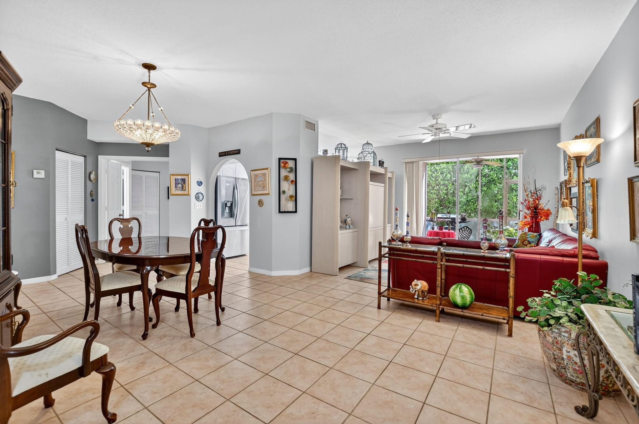 12614 Tiboli Chase Court, Unit 1 Boca Raton, FL 33496 - Photo 10 of 62 a dining room with furniture and a chandelier