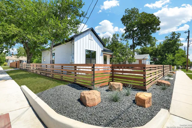 a backyard of a house with table and chairs
