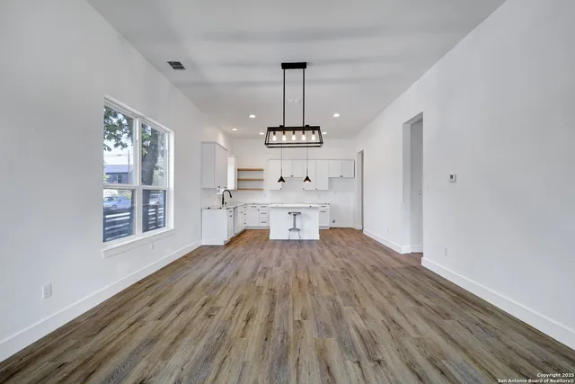 a view of a room with wooden floor windows and cabinet