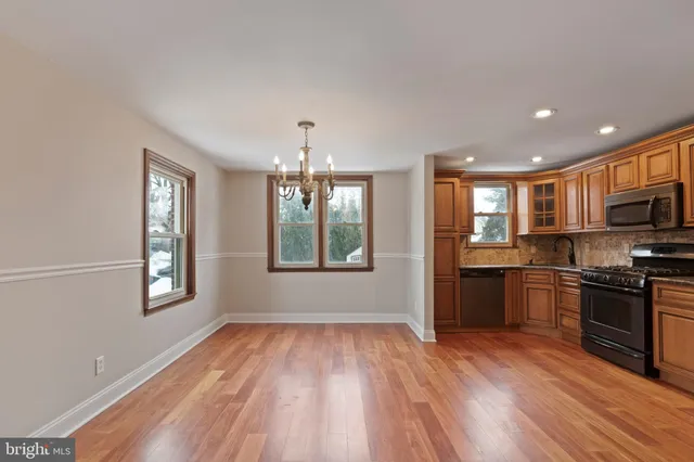 a view of a kitchen with granite countertop stainless steel appliances cabinets and a wooden floor