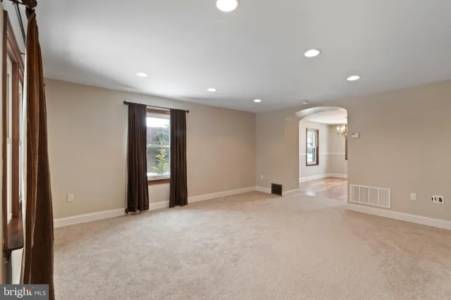 an empty room with windows and entrance