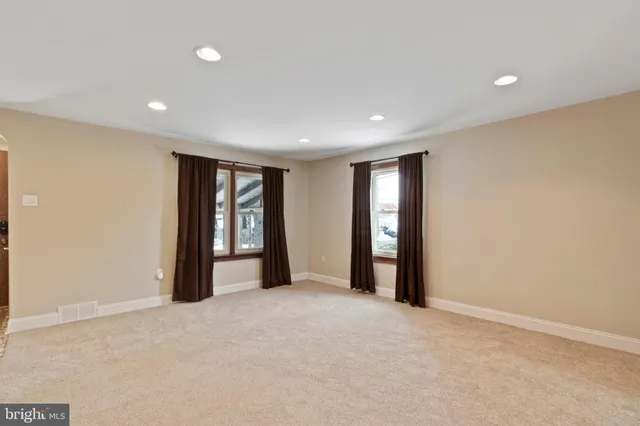 a view of an empty room with closet and wooden floor