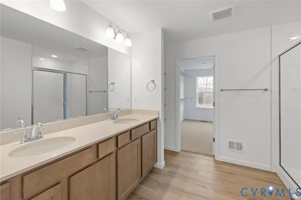 a bathroom with a double vanity sink and a mirror