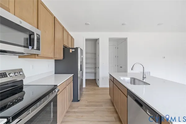 a kitchen with stainless steel appliances granite countertop a sink and a stove