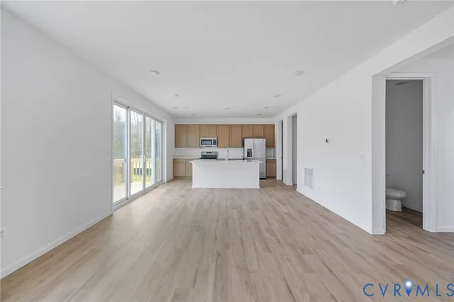 a view of a room with wooden floor and a window