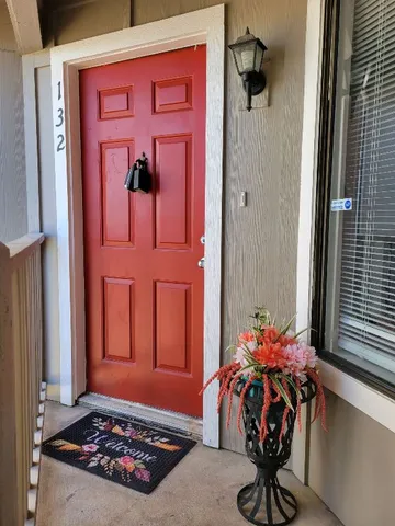 a living room with furniture and flowers