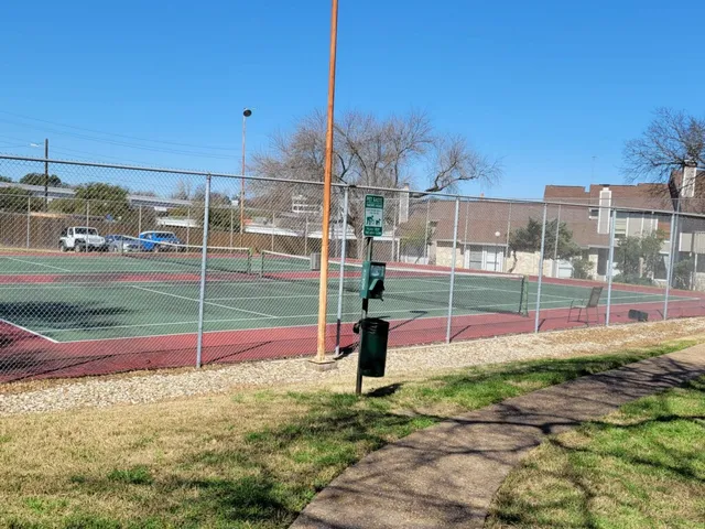 a view of a workspace with wooden floor and a chandelier fan