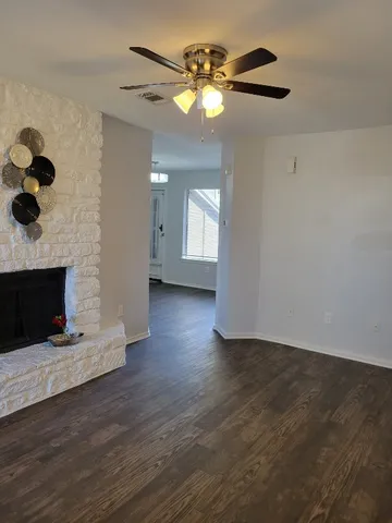 a kitchen with granite countertop white cabinets and black appliances