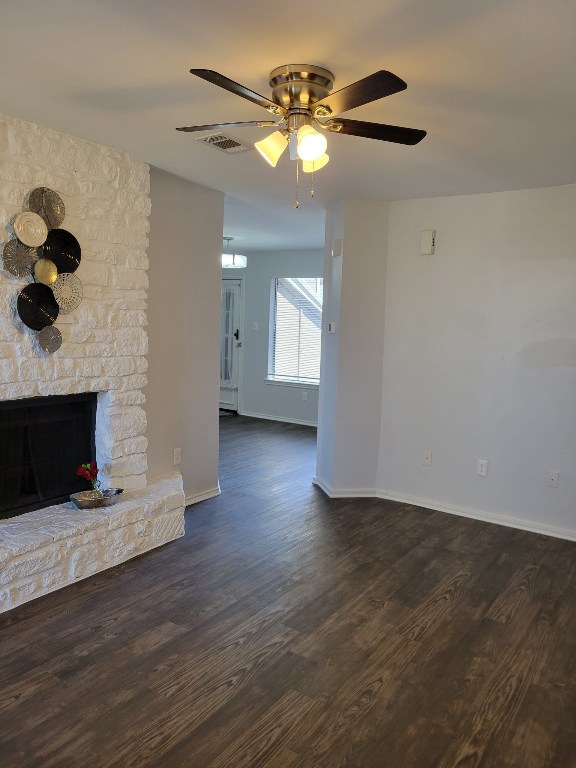 1740 Timber Ridge Road, Unit 132 Austin, TX 78741 - Photo 6 of 16 a view of an empty room with wooden floor and a fireplace