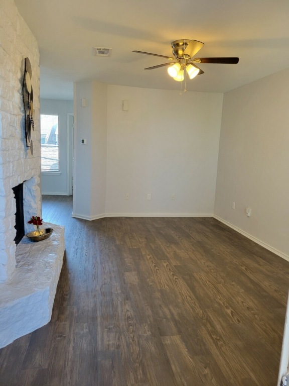 1740 Timber Ridge Road, Unit 132 Austin, TX 78741 - Photo 7 of 16 a view of a workspace with wooden floor and a chandelier fan