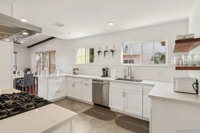 a kitchen with a sink stove and cabinets
