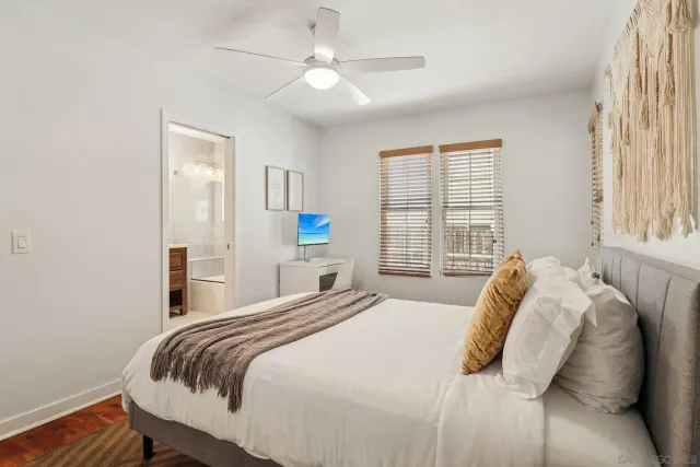 a bedroom with a bed and glass window