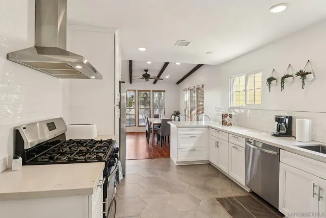a kitchen with stainless steel appliances a refrigerator sink and cabinets