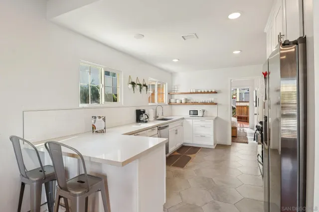 a living room with furniture and a dining table