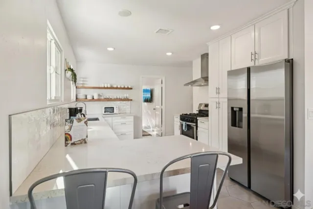 a view of a dining room with furniture and a chandelier