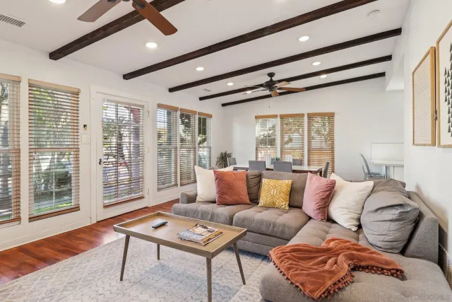 a view of a roof deck with table and chairs with wooden floor and fence